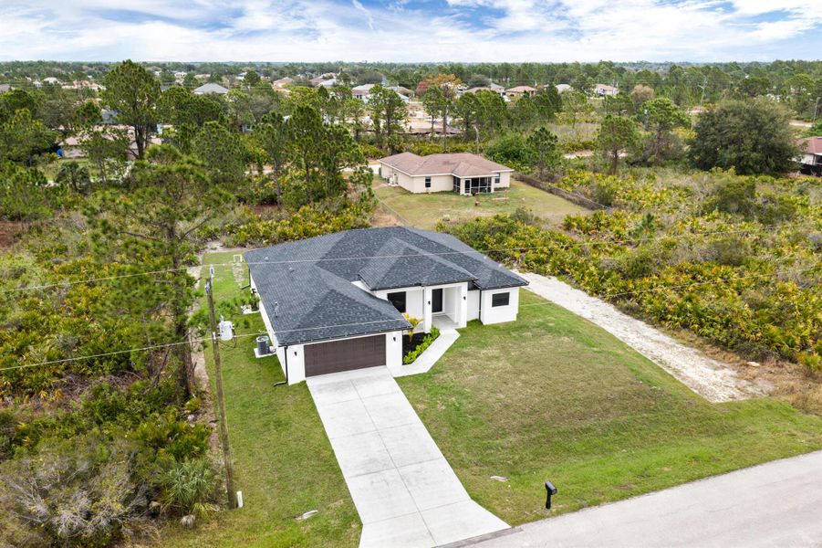 Front exterior of a new home in , Lehigh Acres, FL, highlighting curb appeal (Image 28).