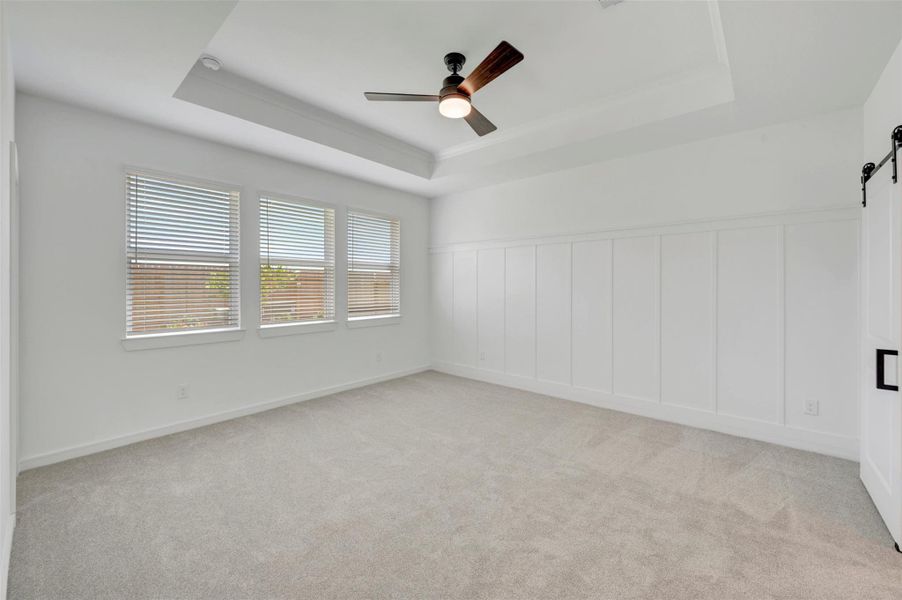 Spacious primary suite with feature wall