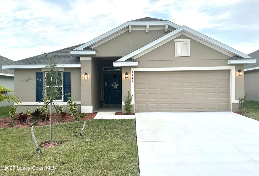 Front exterior of a new home in St. John Preserve, Palm Bay, FL, highlighting curb appeal (Image 2). Front exterior of a new home in St. John Preserve, Palm Bay, FL, highlighting curb appeal (Image 2).