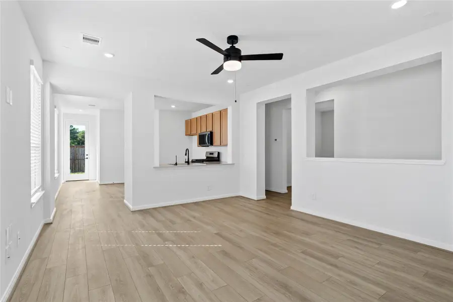 Designed for comfort and connection, this spacious open-concept great room boasts soaring ceilings, large windows with blinds, recessed lighting, and French Oak vinyl plank flooring, seamlessly merging with the stunning kitchen for easy living and entertaining. Designed for comfort and connection, this spacious open-concept great room boasts soaring ceilings, large windows with blinds, recessed lighting, and French Oak vinyl plank flooring, seamlessly merging with the stunning kitchen for easy living and entertaining.