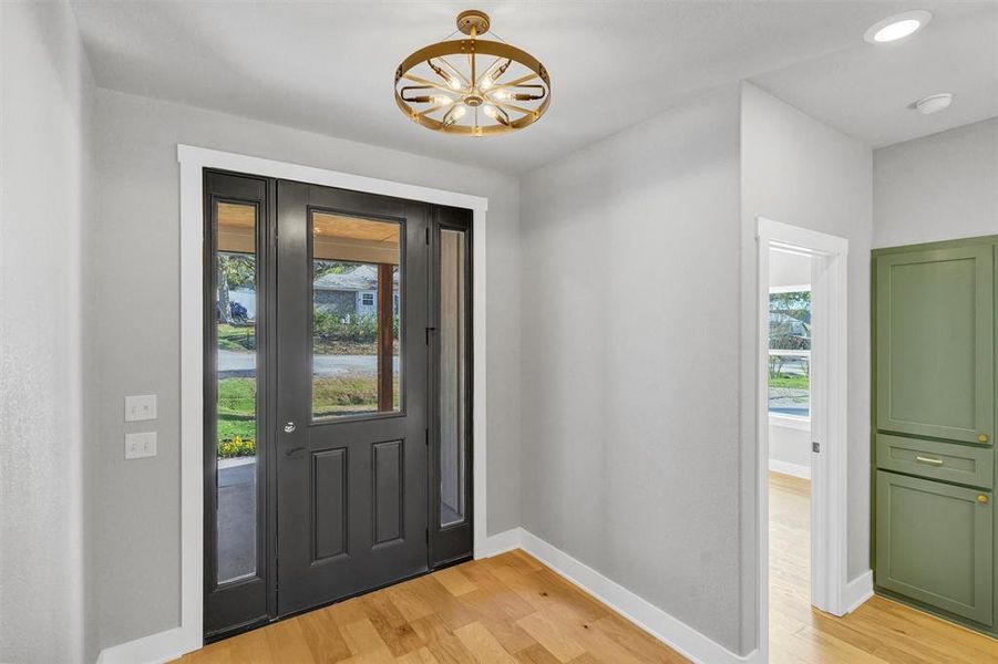 Entrance foyer featuring healthy amount of natural light and light wood-type flooring Entrance foyer featuring healthy amount of natural light and light wood-type flooring