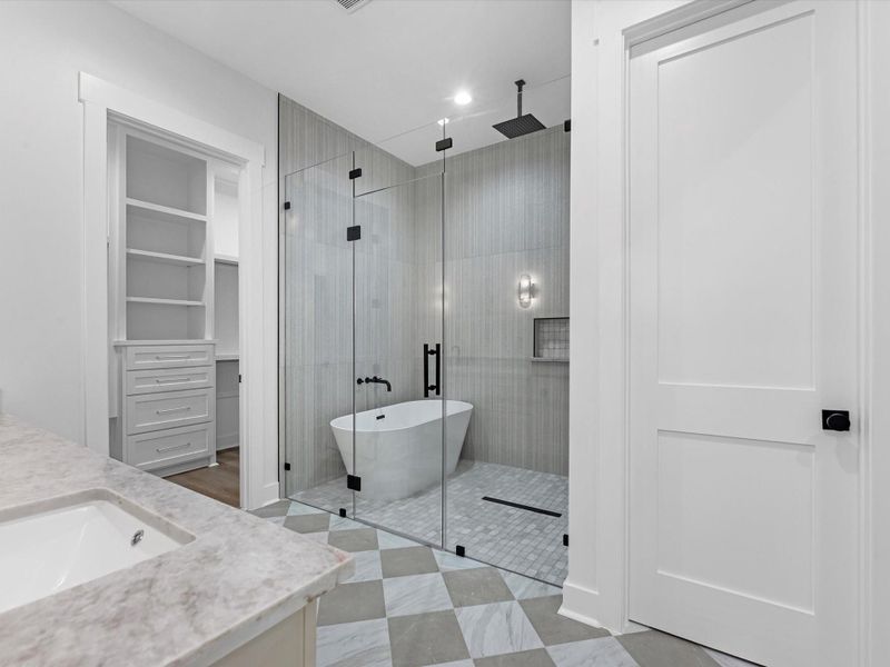 Primary bathroom, featuring free standing tub, and oversized stand up shower. You will also notice separated his and hers closets.