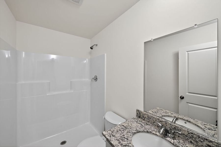 A bathroom with a marble countertop.