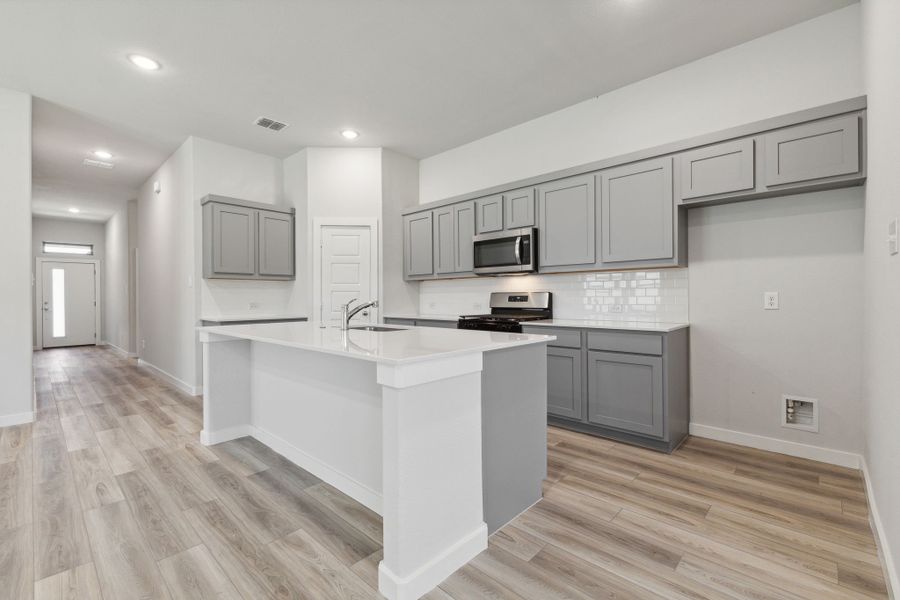 Kitchen in the Quartz home plan by Trophy Signature Homes – REPRESENTATIVE PHOTO