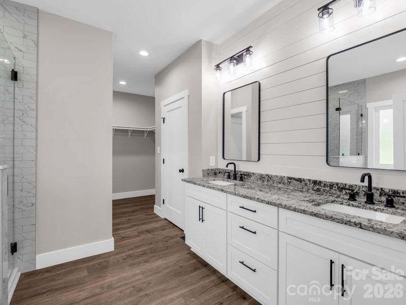 Primary Bath, Granite Counters, soft close cabinets, hardwood floors, Moen faucets, walk in tiled shower and spa like soaking tub Primary Bath, Granite Counters, soft close cabinets, hardwood floors, Moen faucets, walk in tiled shower and spa like soaking tub