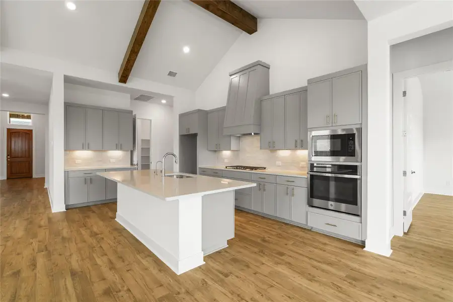 Culinary aspirations come alive in this kitchen, boasting vaulted ceilings and an inviting island, perfect for entertaining. Culinary aspirations come alive in this kitchen, boasting vaulted ceilings and an inviting island, perfect for entertaining.