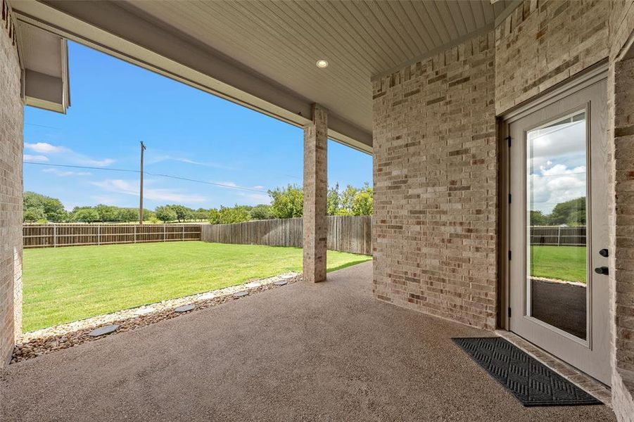Tall covered patio with views of the spacious backyard. Tall covered patio with views of the spacious backyard.
