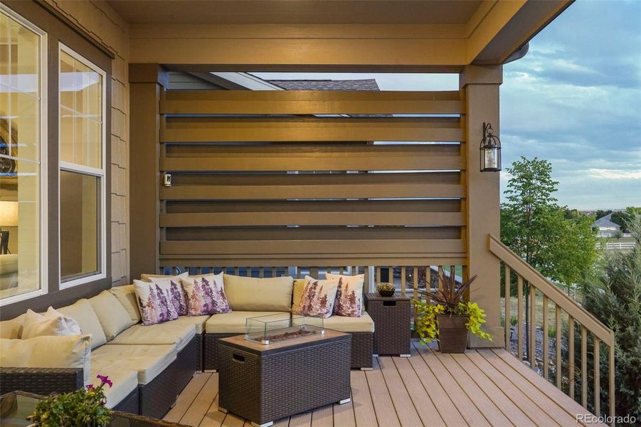 Custom covered deck offering privacy and beauty