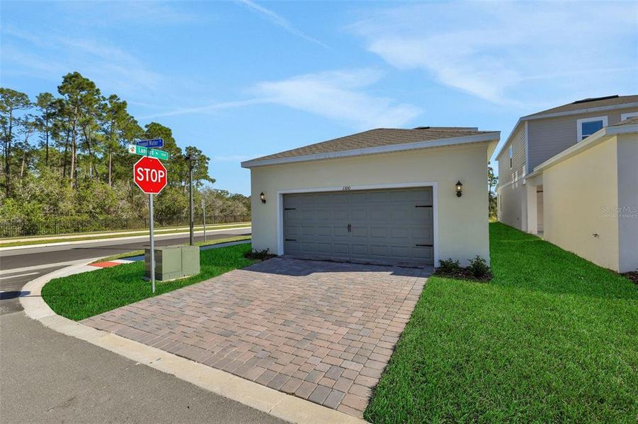 Front exterior of a new home in Serenade at Ovation, Winter Garden, FL, highlighting curb appeal (Image 25).
