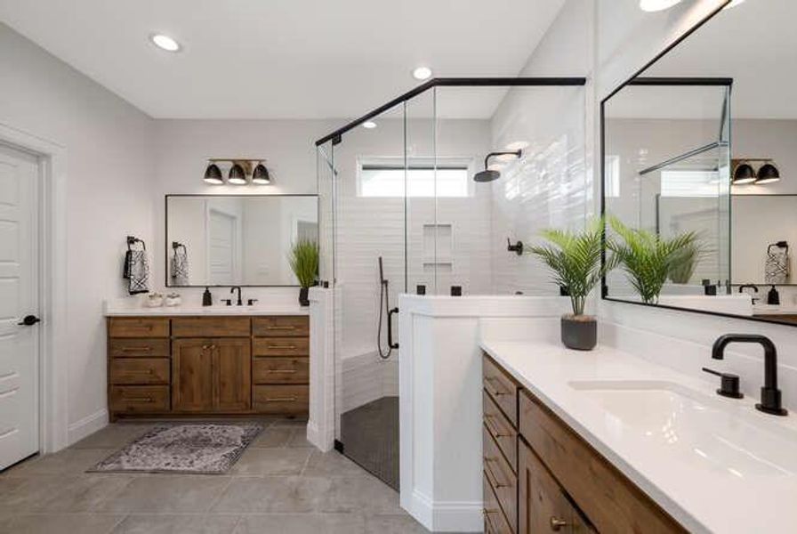 Bathroom featuring two vanities, a shower stall, and recessed lighting Bathroom featuring two vanities, a shower stall, and recessed lighting