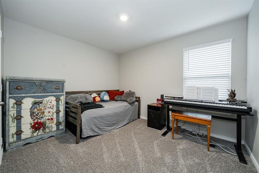 Bedroom with light colored carpet and baseboards Bedroom with light colored carpet and baseboards