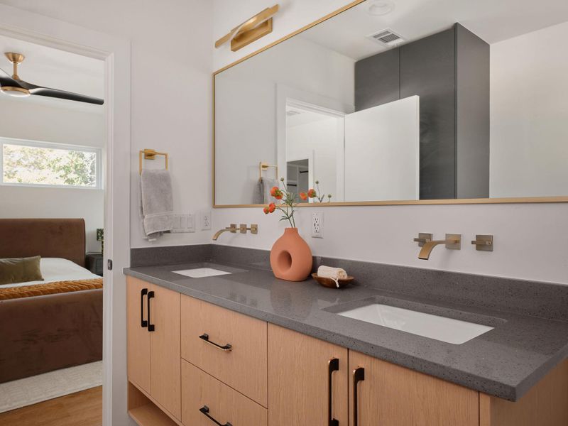 Full bathroom with double vanity, ensuite bathroom, and wood finished floors Full bathroom with double vanity, ensuite bathroom, and wood finished floors