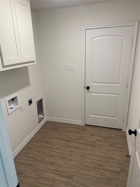 Washroom featuring electric dryer hookup, cabinets, washer hookup, and dark hardwood / wood-style floors