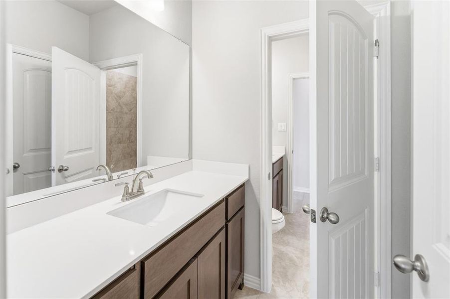 Bathroom featuring vanity and toilet