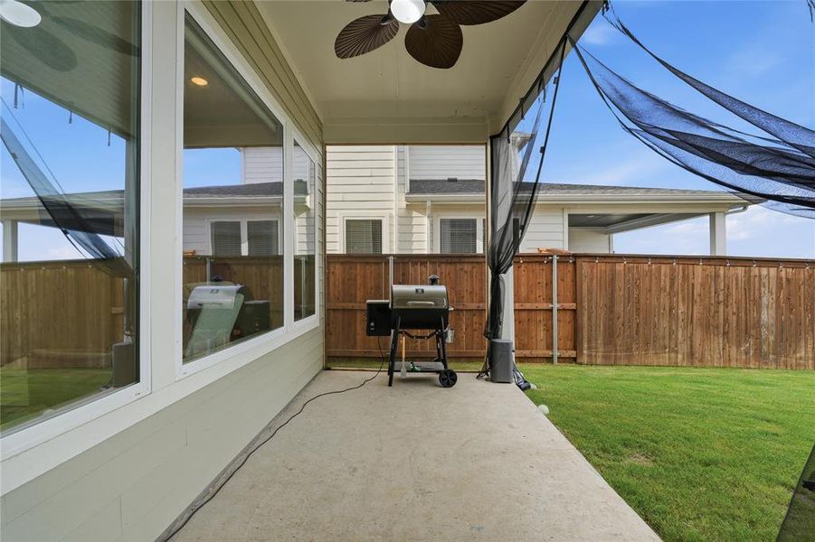 Covered patio featuring a ceiling fan and concrete flooring Covered patio featuring a ceiling fan and concrete flooring