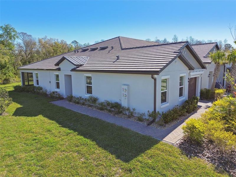 Front exterior of a new home in Angeline Active Adult, Land O' Lakes, FL, highlighting curb appeal (Image 21).