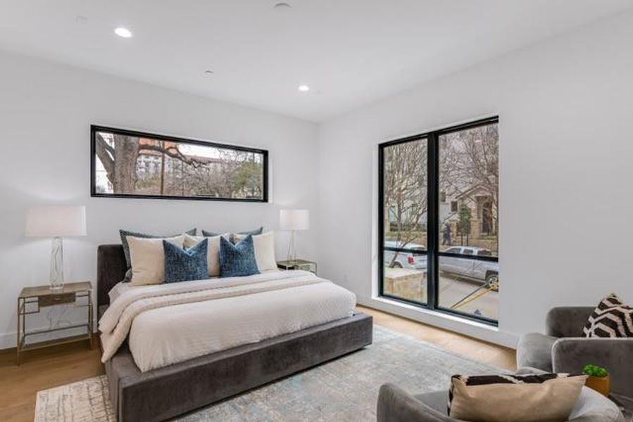 Bedroom featuring baseboards, wood finished floors, recessed lighting, and access to outside