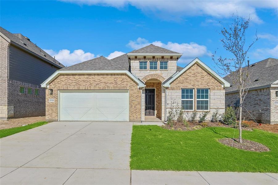 Front facade featuring a garage and a front yard