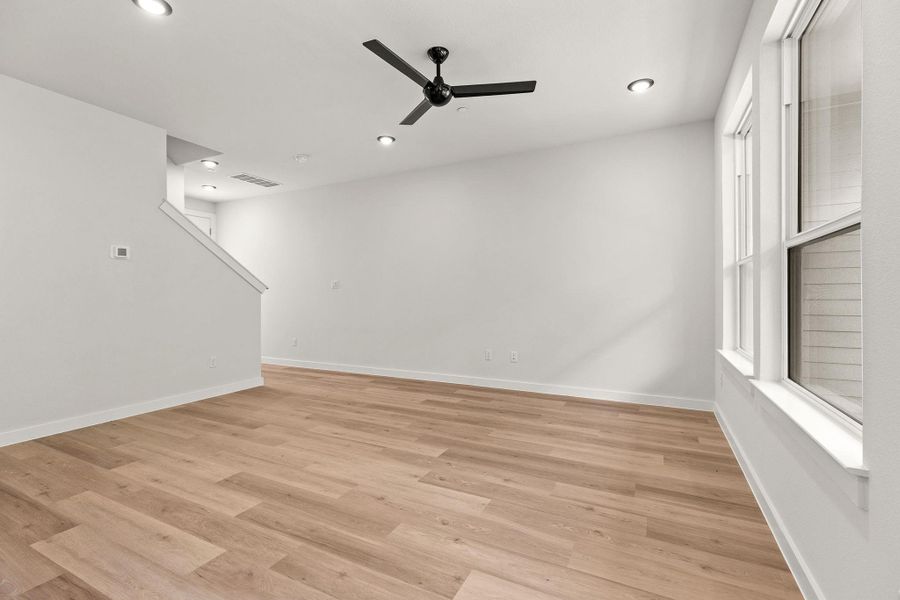 A naturally illuminated living area showcasing a clean aesthetic and practical overhead lighting.