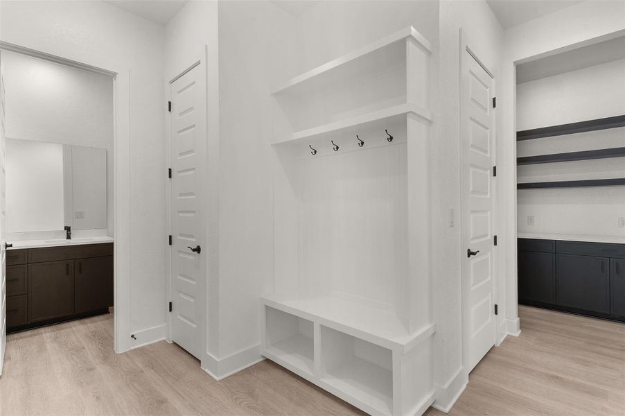Mudroom with light wood-type flooring and a sink Mudroom with light wood-type flooring and a sink