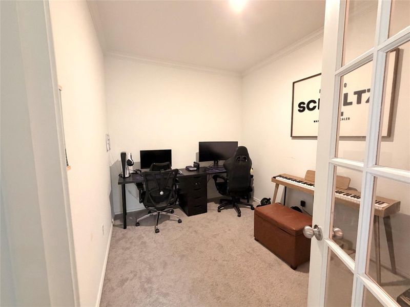 Home office with light colored carpet and ornamental molding Home office with light colored carpet and ornamental molding