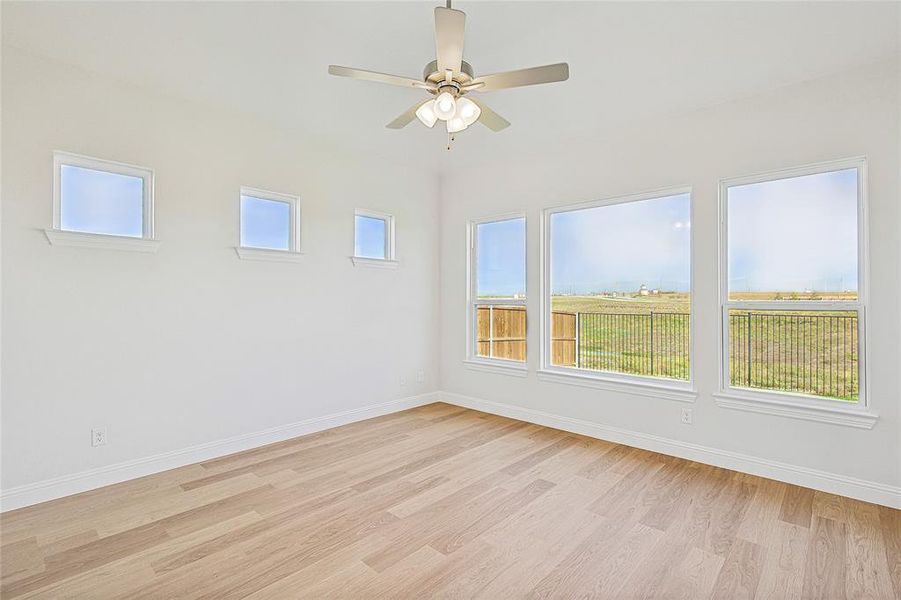 Unfurnished room with ceiling fan and light wood-type flooring