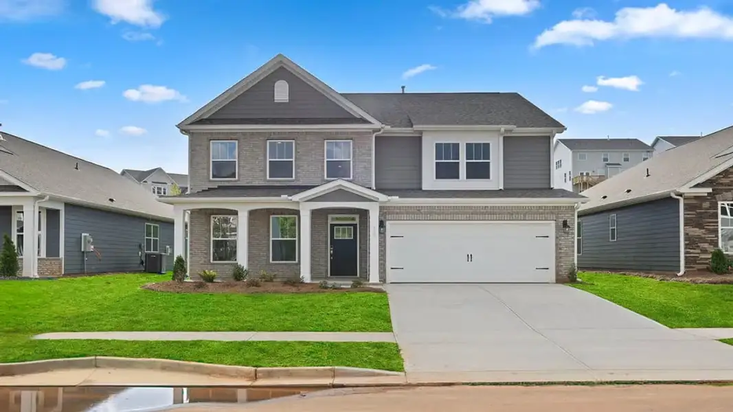 Front exterior of a new home in Spring Ridge Reserve, Anderson, SC, highlighting curb appeal (Image 1). Front exterior of a new home in Spring Ridge Reserve, Anderson, SC, highlighting curb appeal (Image 1).