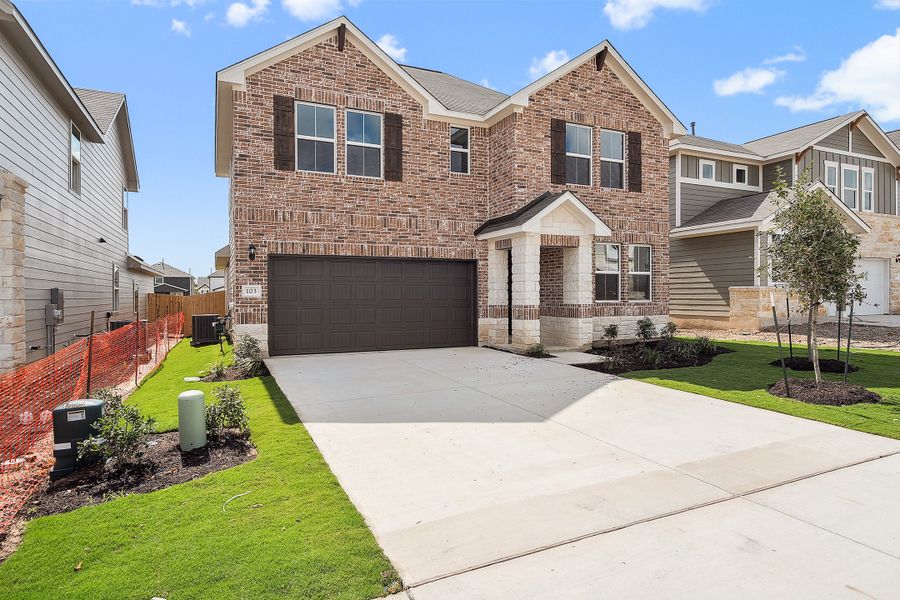 Representative exterior photo of a completed home built from the Blake by Ashton Woods in Rolling Glen, Hutto, TX (Image 25).