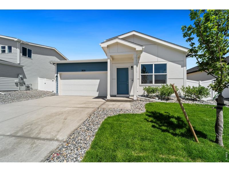 Front exterior of a new home in Liberty Draw, Evans, CO, highlighting curb appeal (Image 2). Front exterior of a new home in Liberty Draw, Evans, CO, highlighting curb appeal (Image 2).