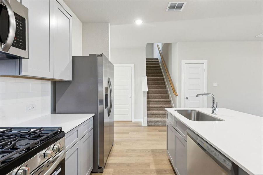 Kitchen in the Haylee home plan by Trophy Signature Homes - REPRESENTATIVE PHOTO