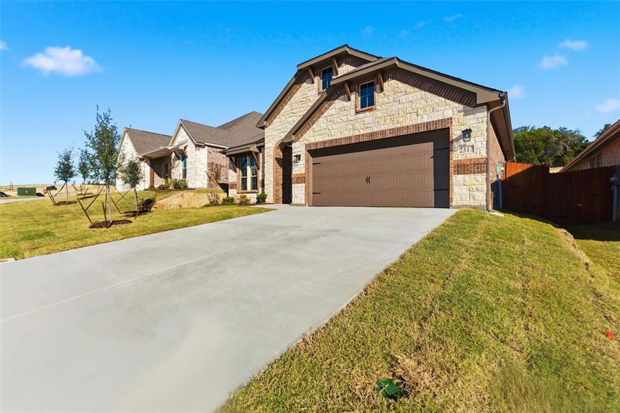 Front exterior of a new home in Waterford Park, Weatherford, TX, highlighting curb appeal (Image 24). Front exterior of a new home in Waterford Park, Weatherford, TX, highlighting curb appeal (Image 24).