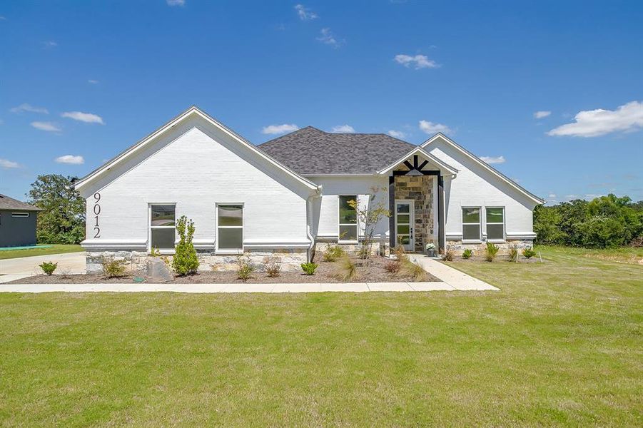 Front exterior of a new home in , Springtown, TX, highlighting curb appeal (Image 2). Front exterior of a new home in , Springtown, TX, highlighting curb appeal (Image 2).