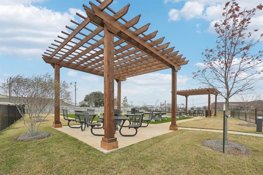 Surrounding community with a yard and a pergola