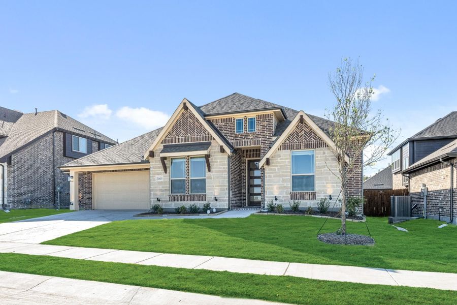 Two-story home with brick and stone exterior, single-car garage, and green front lawn Two-story home with brick and stone exterior, single-car garage, and green front lawn