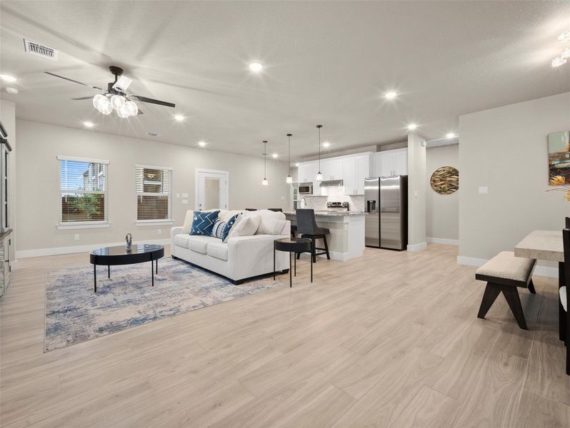 Living room with light wood-type flooring, recessed lighting, and ceiling fan Living room with light wood-type flooring, recessed lighting, and ceiling fan