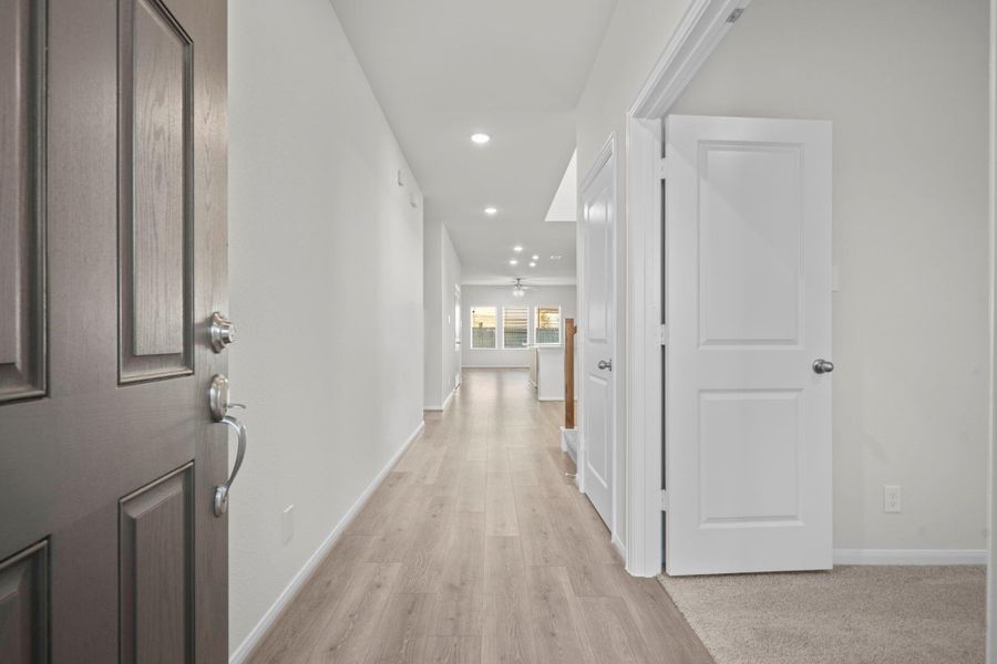 Step inside through the beautiful front door to a bright, open hallway that showcases luxury tile wood flooring, recessed lighting, and a long view toward the spacious family room. Every detail is designed to give a warm and airy feel right from the entryway. Open the French doors to the private tucked away Home Office! Step inside through the beautiful front door to a bright, open hallway that showcases luxury tile wood flooring, recessed lighting, and a long view toward the spacious family room. Every detail is designed to give a warm and airy feel right from the entryway. Open the French doors to the private tucked away Home Office!