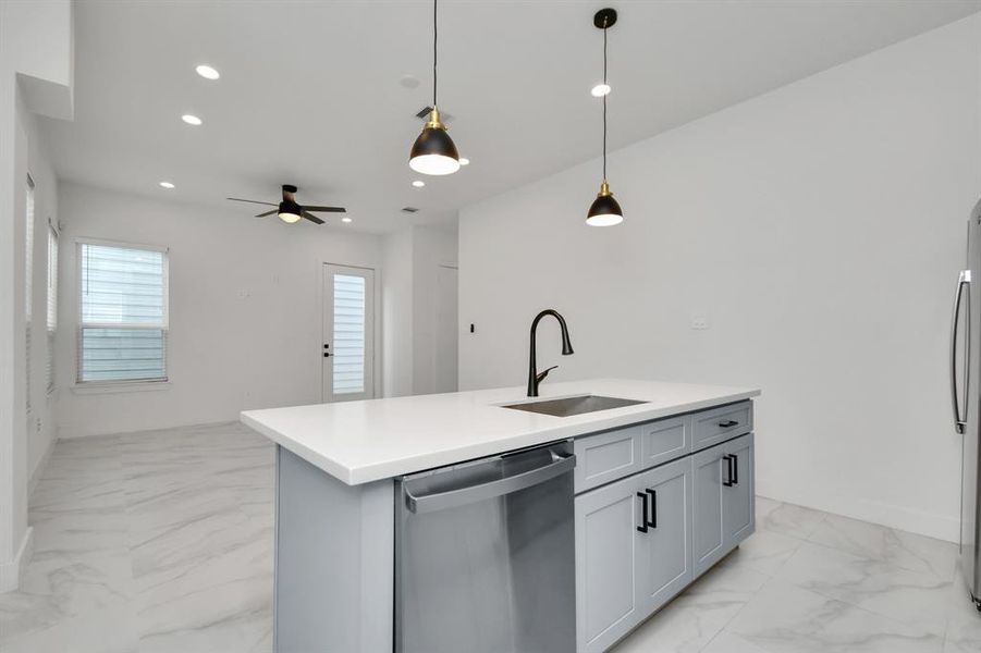 An open kitchen layout that facilitates seamless interaction between the cooking, dining and living spaces