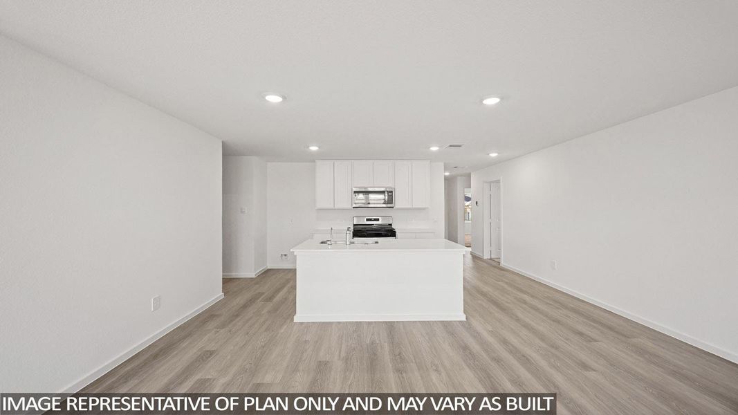 Kitchen with a center island with sink, light wood-style floors, recessed lighting, white cabinetry, and stainless steel appliances
