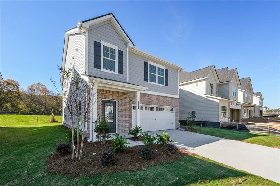 Front exterior of a new home in Neely Farm, Covington, GA, highlighting curb appeal (Image 2). Front exterior of a new home in Neely Farm, Covington, GA, highlighting curb appeal (Image 2).