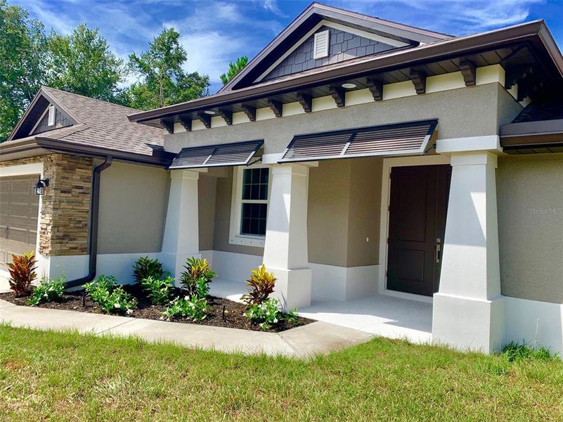 Front exterior of a new home in , North Port, FL, highlighting curb appeal (Image 28). Front exterior of a new home in , North Port, FL, highlighting curb appeal (Image 28).