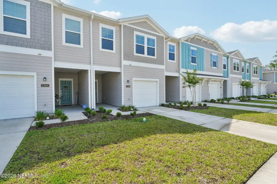 Front exterior of a new home in Longbay Townhomes, Middleburg, FL, highlighting curb appeal (Image 24).