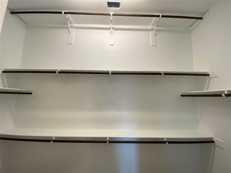 Master closet offers a 3rd rail for extra seasonal storage. Master closet offers a 3rd rail for extra seasonal storage.