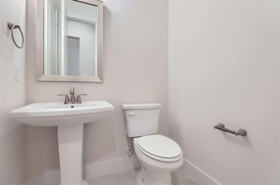 Bathroom featuring tile patterned floors and toilet