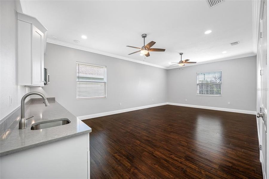 Wet bar with wine fridge and microwave in rec room