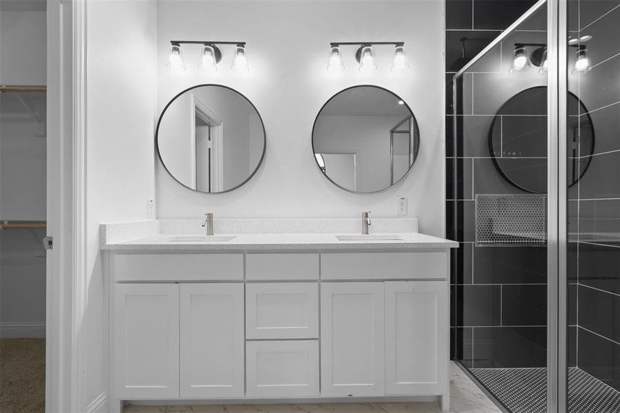 Bathroom featuring vanity and a shower with shower door