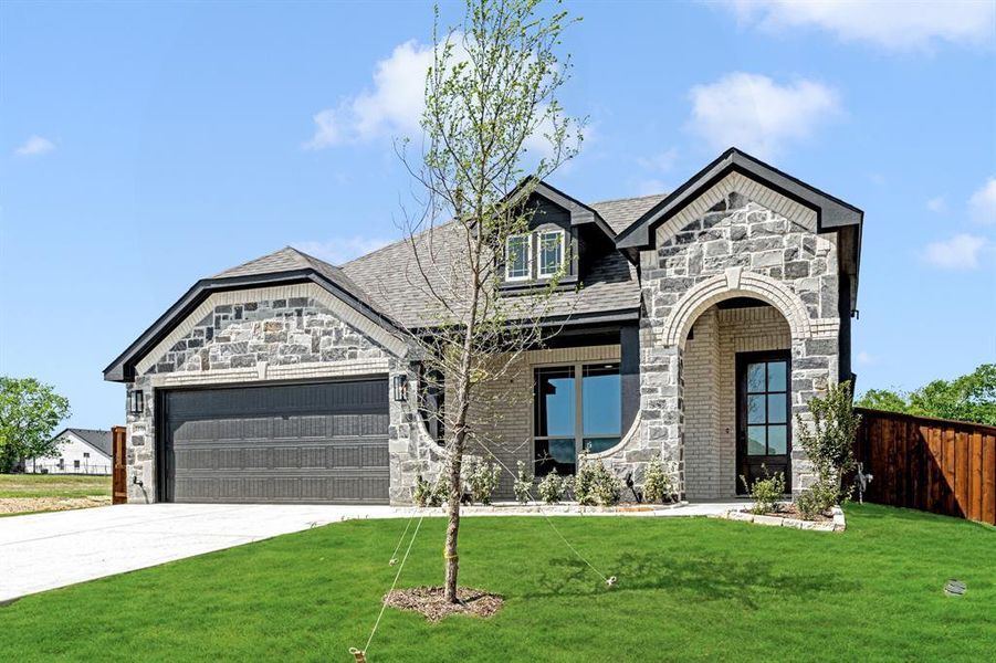 Front exterior of a new home in Wildcat Ridge Phase 3, Godley, TX, highlighting curb appeal (Image 2). Front exterior of a new home in Wildcat Ridge Phase 3, Godley, TX, highlighting curb appeal (Image 2).