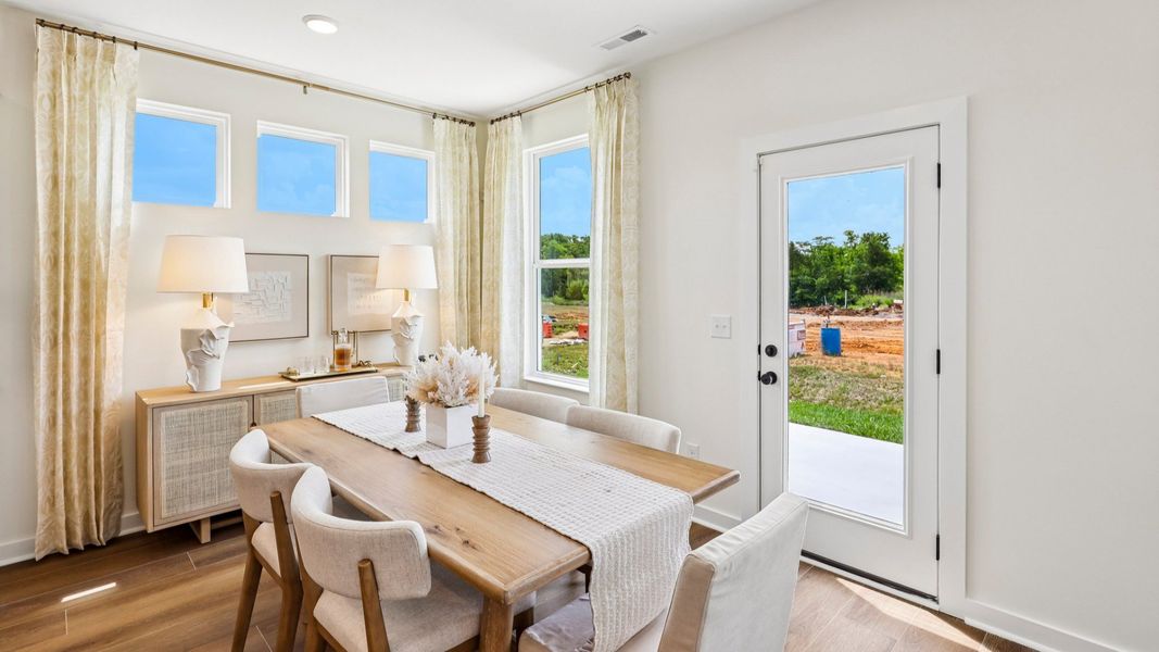 Dining area with natural lighting from windows and access to rear entrance Dining area with natural lighting from windows and access to rear entrance