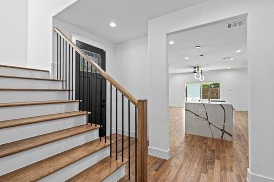 Stairs featuring wood-type flooring