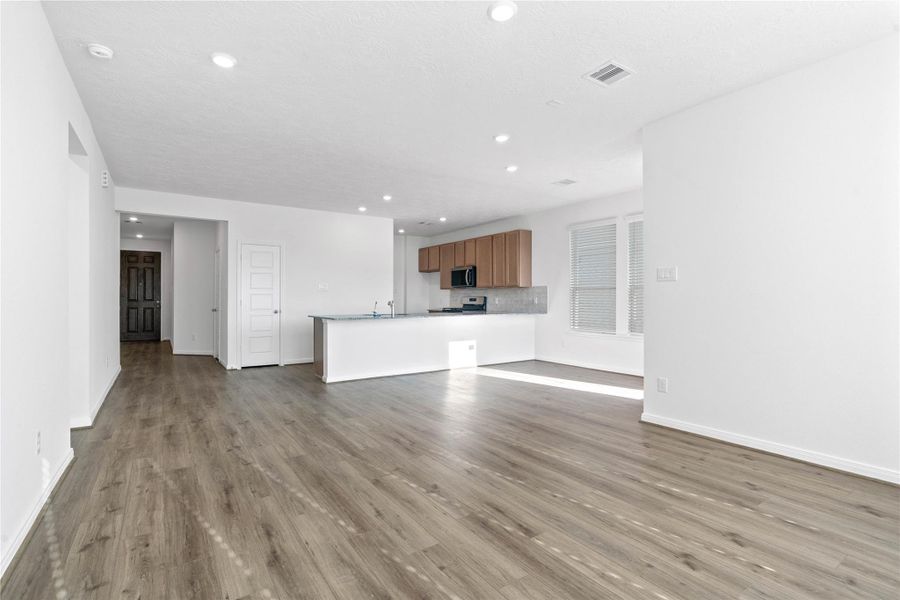 Stunning open-concept design seamlessly connecting the living, dining, and kitchen areas—perfect for both everyday living and entertaining!