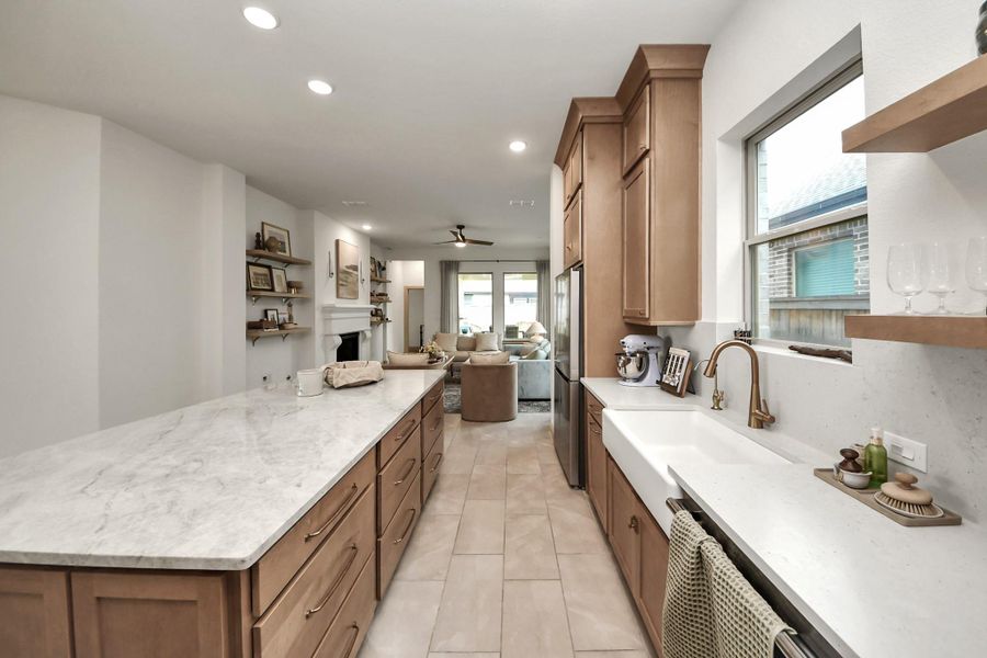 Experience seamless living in this elegant home with an open kitchen effortlessly flowing from the dining area to the inviting living room.